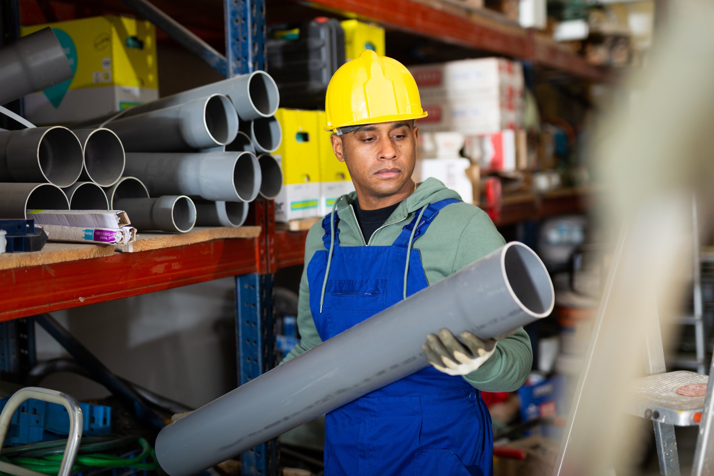 Latin american handyman man choosing building materials in store